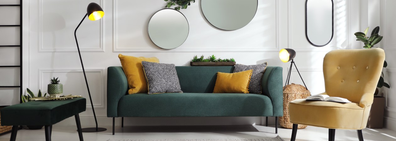 Modern eingerichtetes Wohnzimmer mit gepflegtem Sofa, Sesseln und sauberen Möbeloberflächen als Teaserbild zum Thema Möbelpflege und Wohnraumpflege